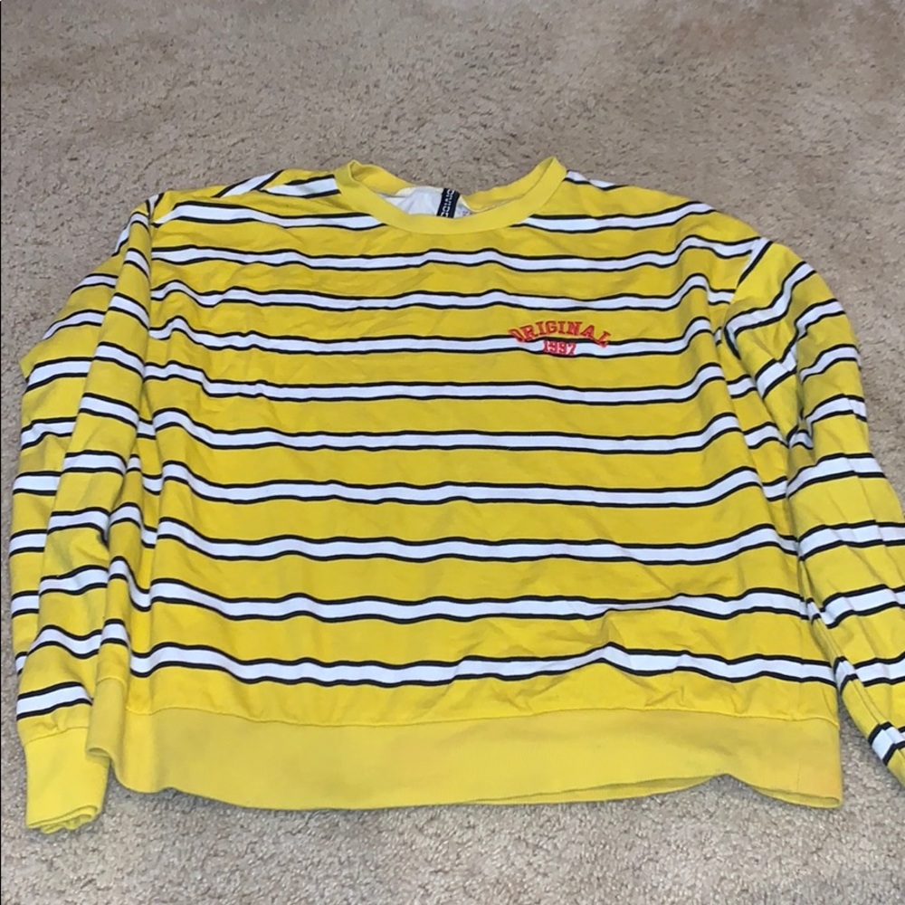 Yellow, white and black long sleeve. Red detailing